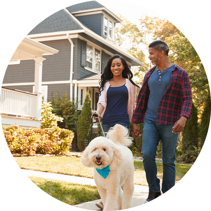 Family walking dog in neighborhood